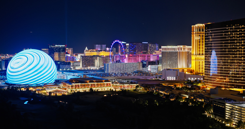 The Las Vegas skyline at night, with the lights of the casinos and hotels illuminating the sky.
