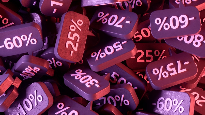 A jumbled pile of discount tags with various sale percentages.