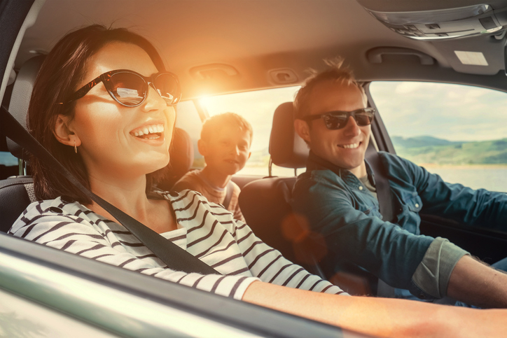  A happy family traveling by car with the windows down, enjoying the beautiful weather.
