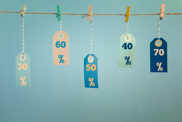 Five paper tags showing discounts hang from a clothesline with clothespins.
