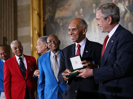 U.S. President George W. Bush presents the Congressional Gold Medal to Dr. Roscoe Brown Jr., during ceremonies honoring the Tuskegee Airmen Thursday, March 29, 2007, at the U.S. Capitol. (White House Photo)