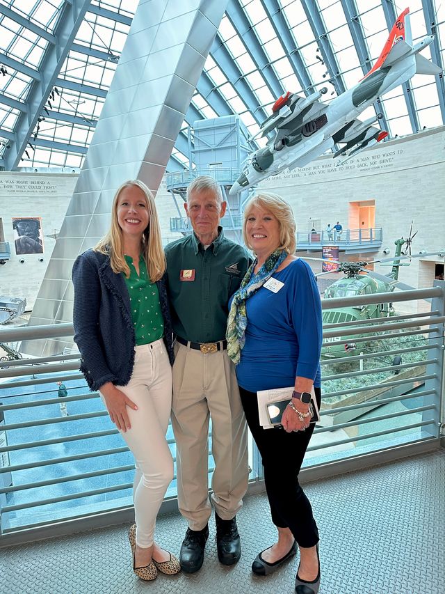 Darley Newman at the National Museum of the Marine Corps with marine and PR director, Gwenn Adams, and marine and docent, Wally Jabs. Adjacent to Marine Corps Base Quantico, Virginia, and under the command of Marine Corps University, the design of the Museum evokes the images of the flag raisers of Iwo Jima. Visitors would enjoy world-class interpretive exhibits with innovative technology and unique artifacts and immerse themselves in the sights and sounds of Marines in action.