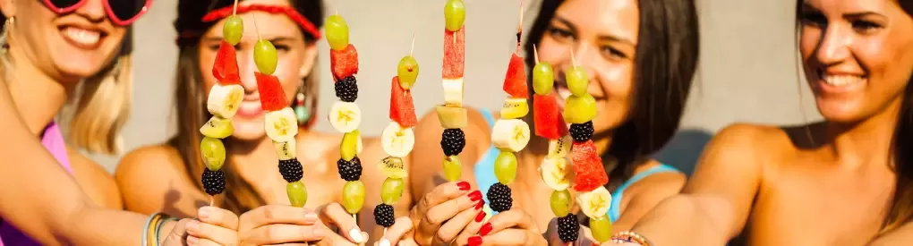 fruitbouquets.com deal hero girls eating fruit kabobs