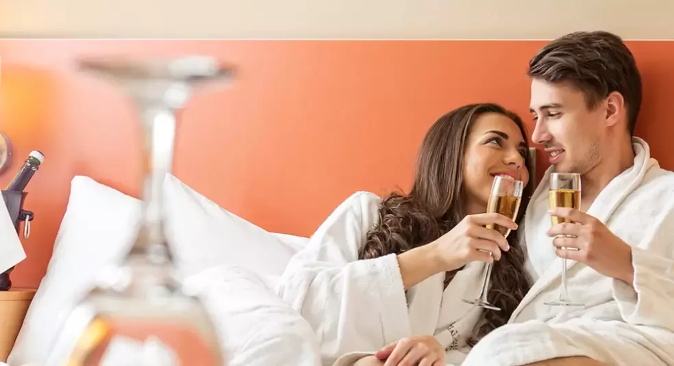 Wyndham hotels and resorts worldwide deal hero romantic couple on hotel bed