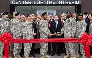 Ribbon Cutting with the Troops. at the center are Arnold Fisher, Richard Santulli (Chairman, Intrepid Fallen Heroes Fund) and Dr. Francis Harvey (Former Secretary of the Army)