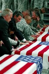 Members of the International Security Assistance Force and senior officials from the U.S. Embassy in Kabul, Afghanistan, pay their respects to nine U.S. soldiers killed in Nuristan province during a ramp ceremony at Bagram Air Field, Afghanistan. State Department 