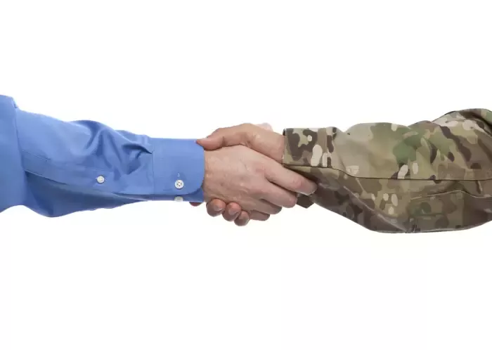 corporate hand shaking military hand