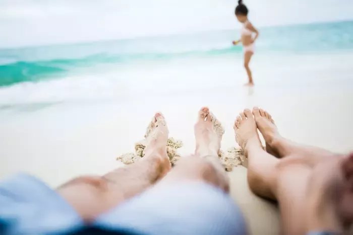 couple on beach with child