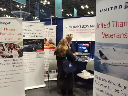 Co-Founder and Chief Operating Officer Lin Higgins helping an attendee enroll in Veterans Advantage at the New York Times Travel Show.