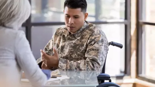 Paraplegic soldier talks with female therapist