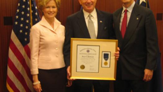 Bob McFarland (center), honored by the VA, accompanied by his wife Susan and Scott Higgins (right).